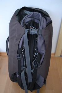 Small day pack hooked onto back of large backpack
